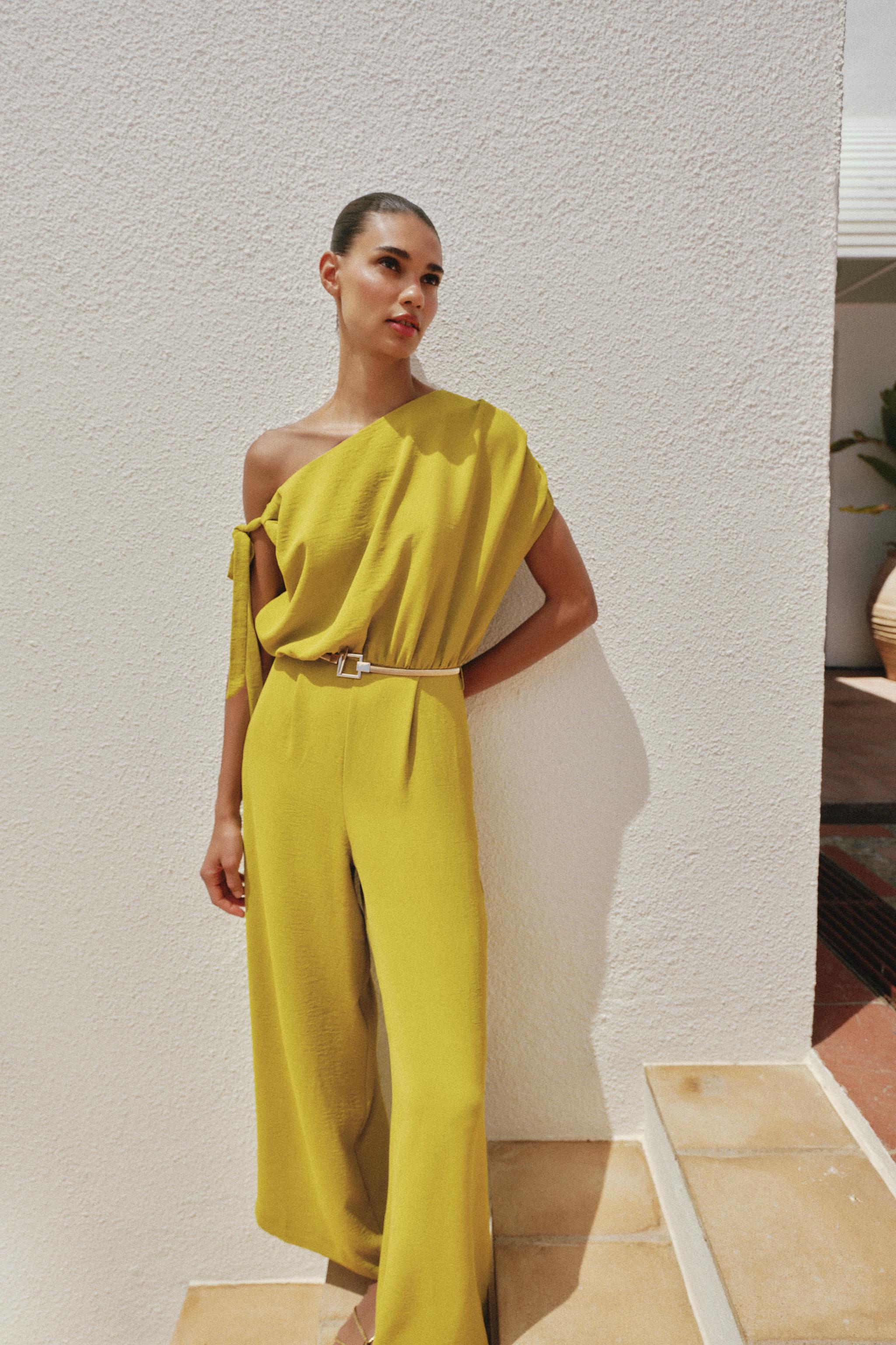 ASYMMETRIC SLEEVE BELTED JUMPSUIT